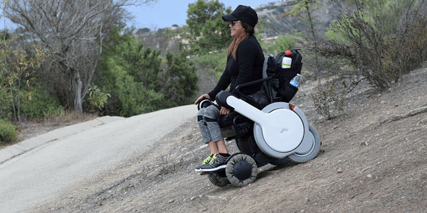 Woman Going Down Hill on All Terrain Wheelchair